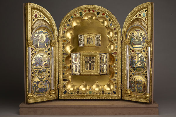 Tryptich with full arch in the middle and half arch on either side gold with red, green, blue gemstoneds and enameled roundels.