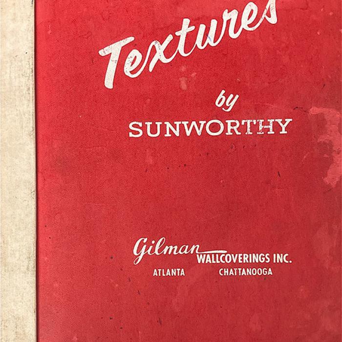 Red sketchbook cover with off-white text that says Textures by Sunworthy Gilamn wallcoerings Inc. Atlanta Chatanooga.